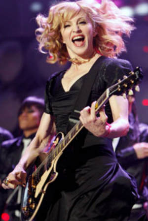 Madonna Louise Ciccone playing guitar onstage