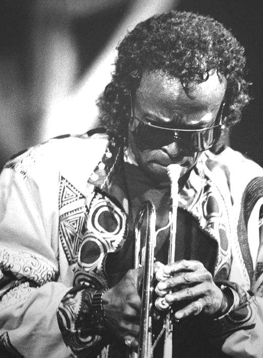 mature Miles Davis playing trumpet
