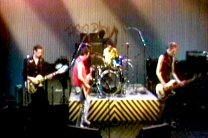 The Clash performing with a graffiti artist