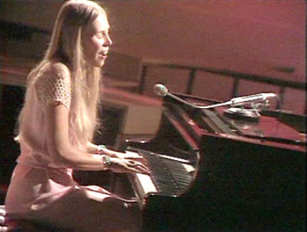 beautiful young Joni Mitchell playing piano