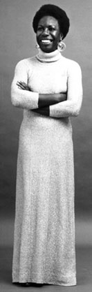 smiling Nina Simone in a white dress