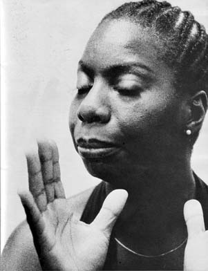 Nina Simone with eyes closed and hands open