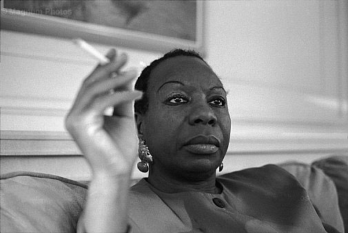 somber looking Nina Simone smoking a cigarette