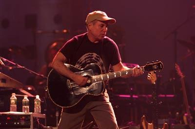 Paul Simon plays guitar