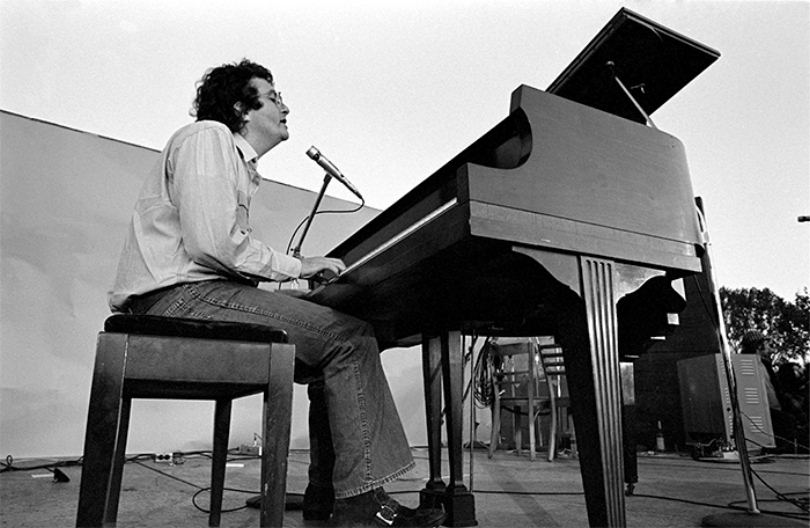 beautiful image of Randy Newman playing piano on stage