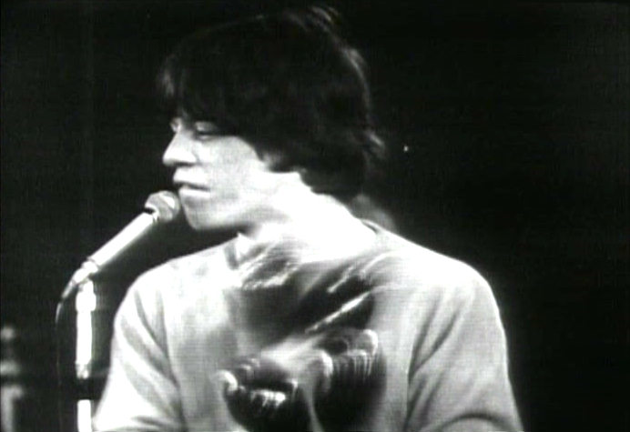 Mick Jagger playing maracas