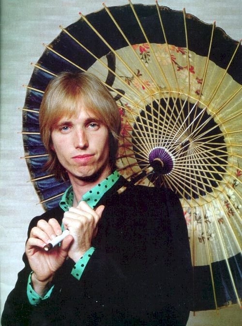 Pretty young Tom Petty with a parasol