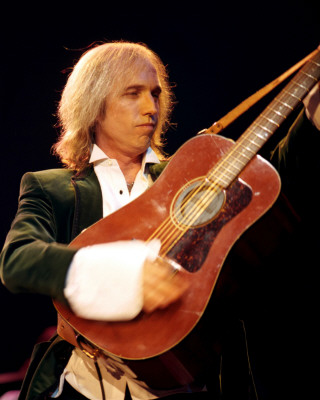 Tom Petty playing acoustic guitar
