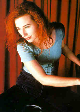 Tori Amos looks away from her piano