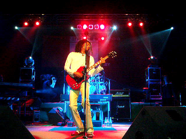 Terence Trent D'Arby aka Sananda Maitreya playing guitar on stage