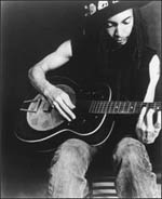 Terence Trent D'Arby playing an acoustic guitar