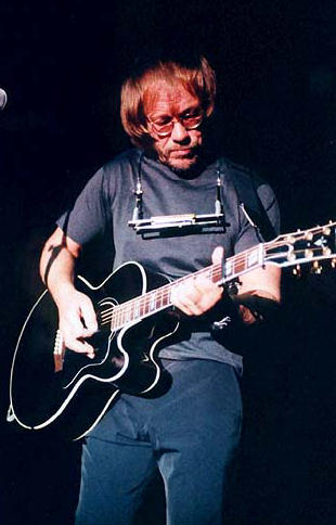 Warren Zevon playing guitar