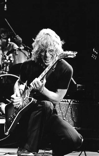 black and white picture of Warren Zevon getting down