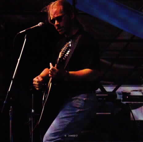 Warren Zevon playing guitar