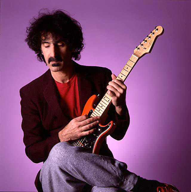 Frank Zappa plays a tiny guitar