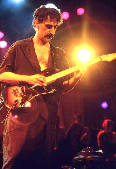 Frank Zappa playing guitar on stage