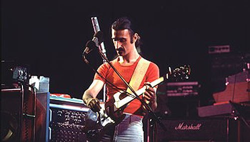 Frank Zappa plays guitar on stage