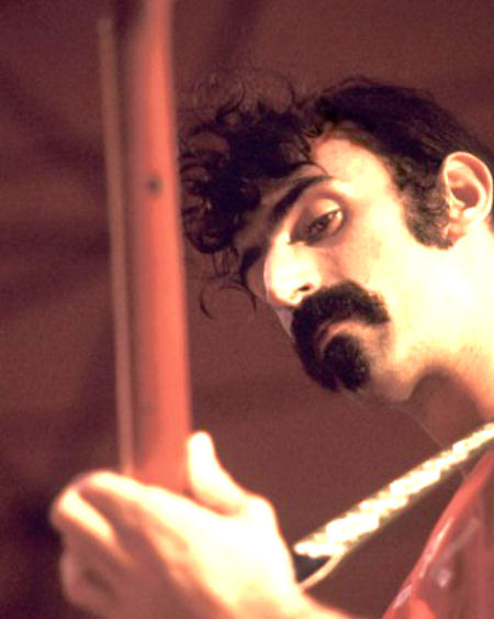 Frank Zappa concentrates on his guitar playing