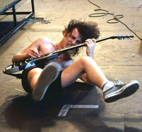 Angus Young in a fit of pentecostal ecstasy writhing on the floor