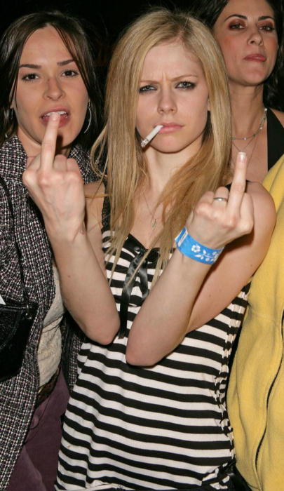 Avril Lavigne smoking a cigarette and flipping the bird